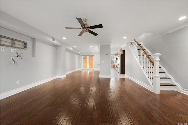 unfurnished living room with dark hardwood / wood-style floors and ceiling fan