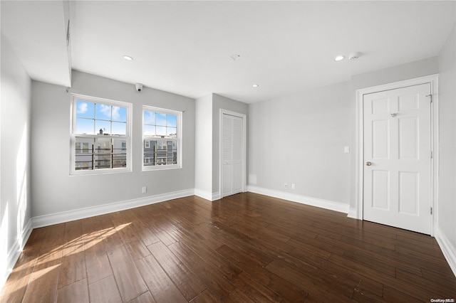 spare room with dark wood-type flooring