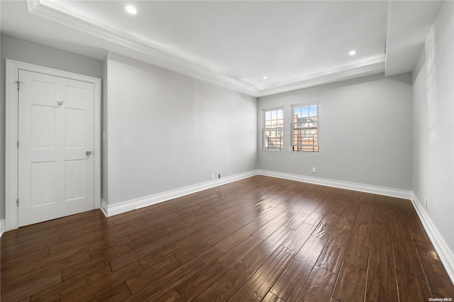 unfurnished room with a tray ceiling and dark hardwood / wood-style flooring