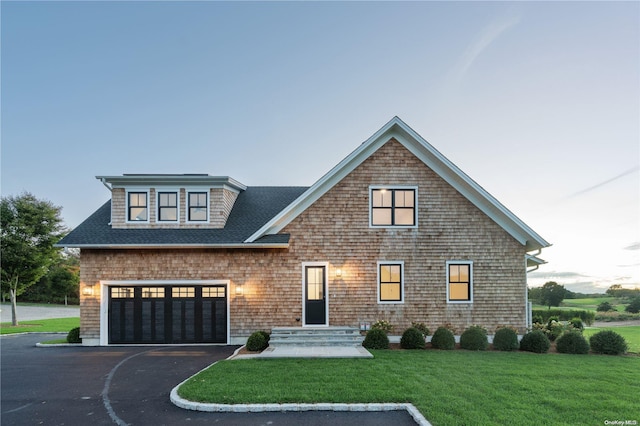 front of property featuring a yard and a garage