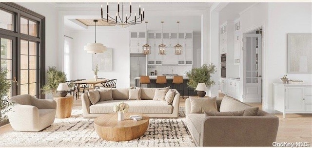 living room featuring ornamental molding, light wood-type flooring, and a notable chandelier