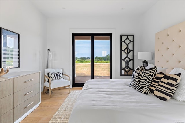 bedroom with access to outside and light hardwood / wood-style floors