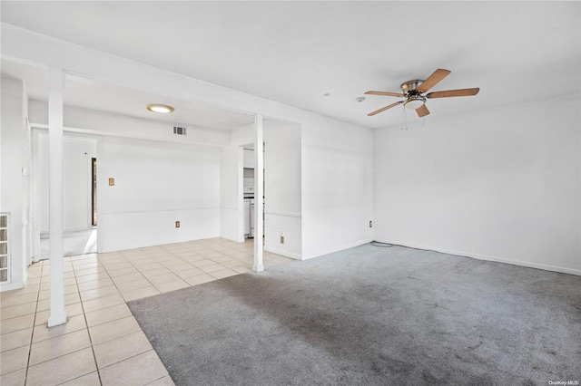 empty room with ceiling fan and light tile patterned flooring