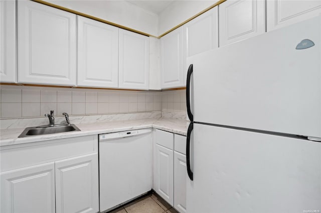 kitchen with tasteful backsplash, sink, white cabinets, and white appliances