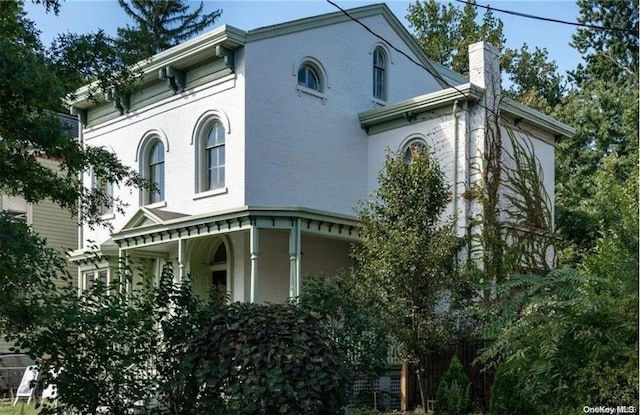 view of side of property with a porch