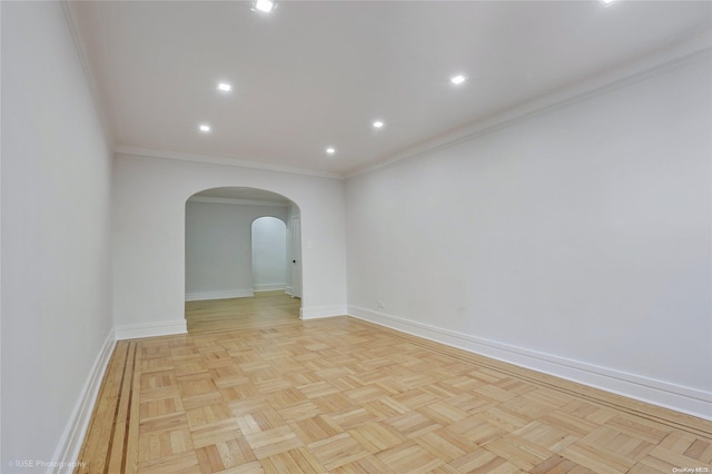 empty room featuring light parquet floors and ornamental molding