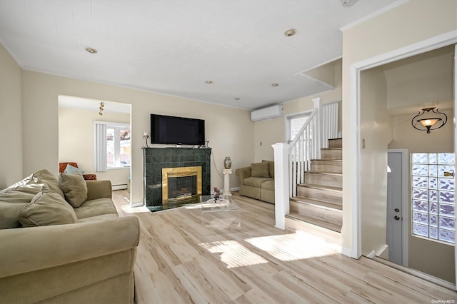 living room featuring light hardwood / wood-style flooring, a wall unit AC, a baseboard heating unit, and a tiled fireplace