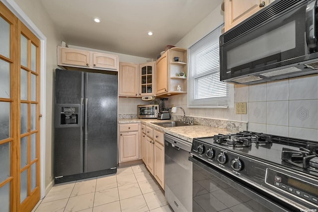 kitchen with decorative backsplash, light brown cabinets, sink, and black appliances