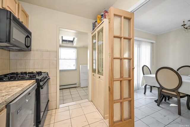 kitchen with light brown cabinets, a baseboard heating unit, crown molding, appliances with stainless steel finishes, and tasteful backsplash