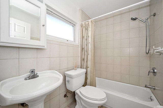 full bathroom featuring sink, tasteful backsplash, toilet, shower / tub combo with curtain, and tile walls