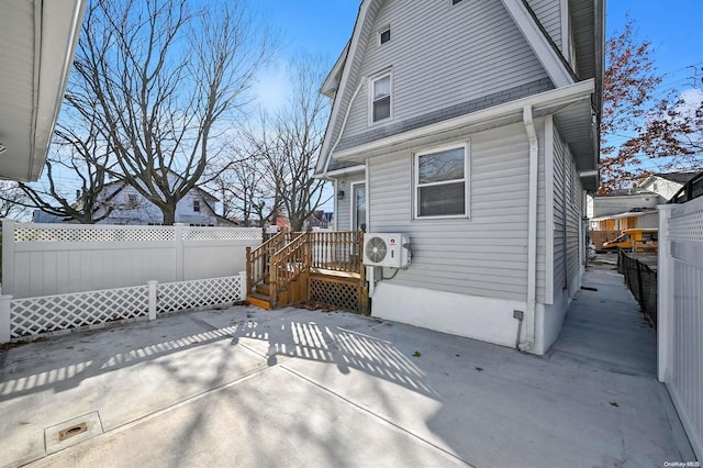 back of house with ac unit and a patio