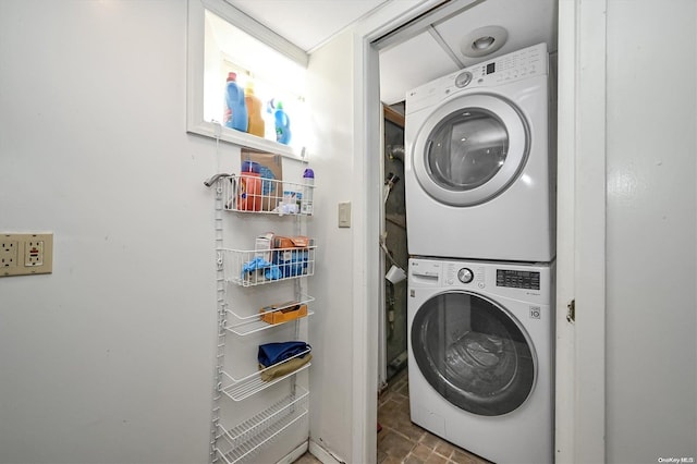 clothes washing area with stacked washer / drying machine