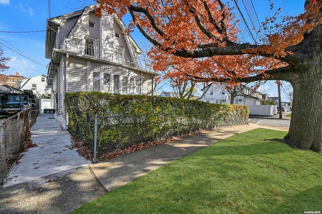 exterior space featuring a balcony and a yard