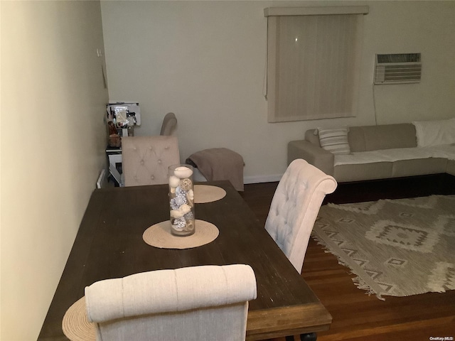 dining space featuring dark hardwood / wood-style floors and an AC wall unit