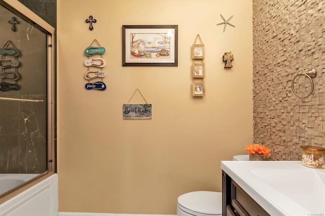 full bathroom with vanity, toilet, and enclosed tub / shower combo