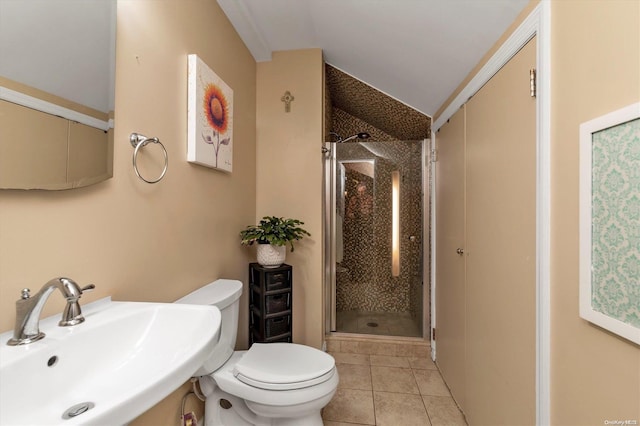 bathroom with toilet, sink, an enclosed shower, and tile patterned flooring