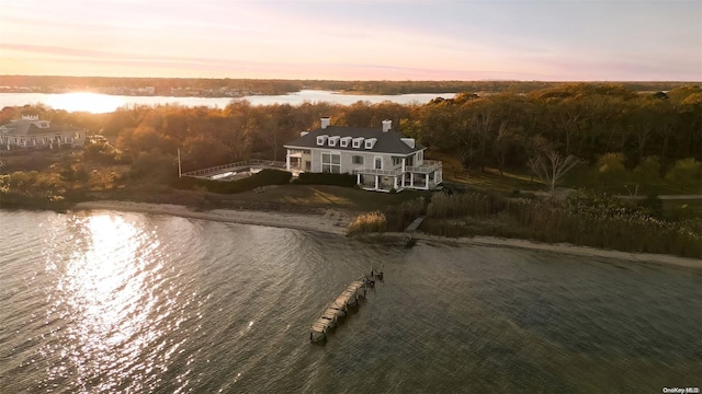 aerial view at dusk with a water view