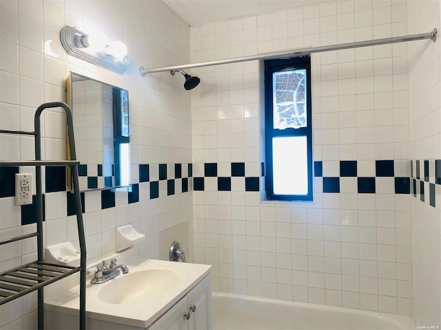 bathroom with vanity, tile walls, backsplash, and tiled shower / bath