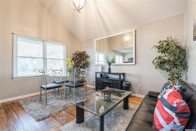 living room with hardwood / wood-style floors and high vaulted ceiling