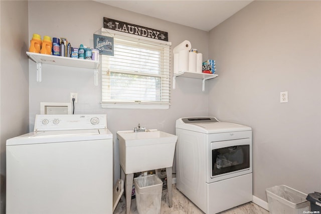 washroom featuring independent washer and dryer and sink