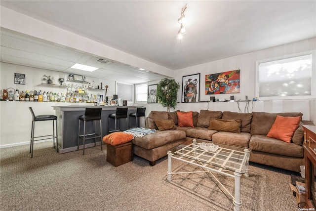 carpeted living room with bar