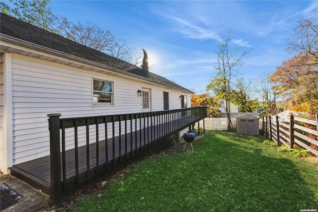 view of yard featuring a wooden deck and a shed