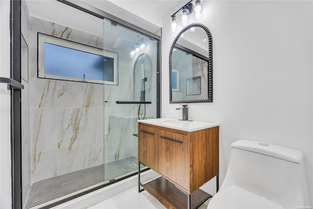 bathroom with vanity, a shower with shower door, and toilet