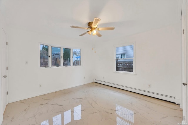 spare room featuring ceiling fan and a baseboard heating unit