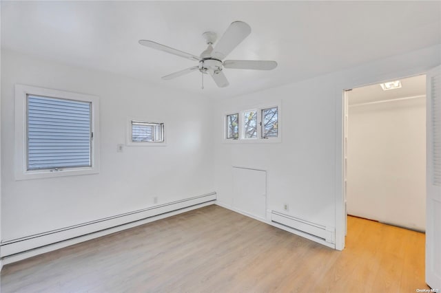 empty room with light wood-type flooring, baseboard heating, and ceiling fan