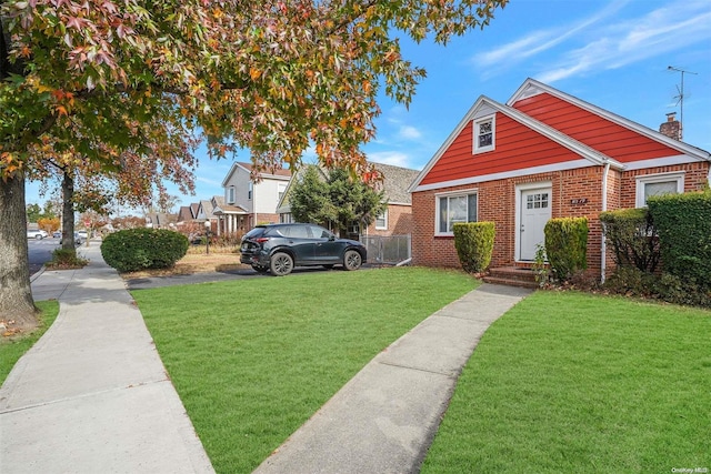 bungalow-style home with a front yard