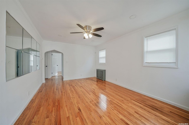 unfurnished room featuring ceiling fan, crown molding, and light hardwood / wood-style flooring