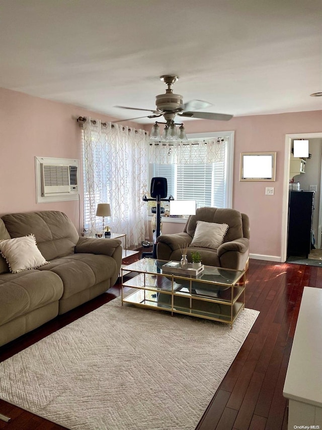 living room featuring dark hardwood / wood-style floors, an AC wall unit, and ceiling fan