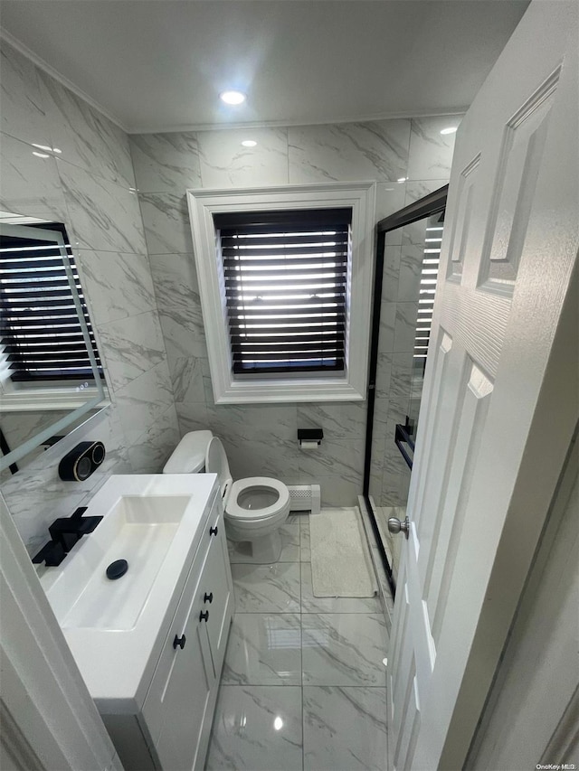 bathroom with vanity, toilet, tile walls, and walk in shower