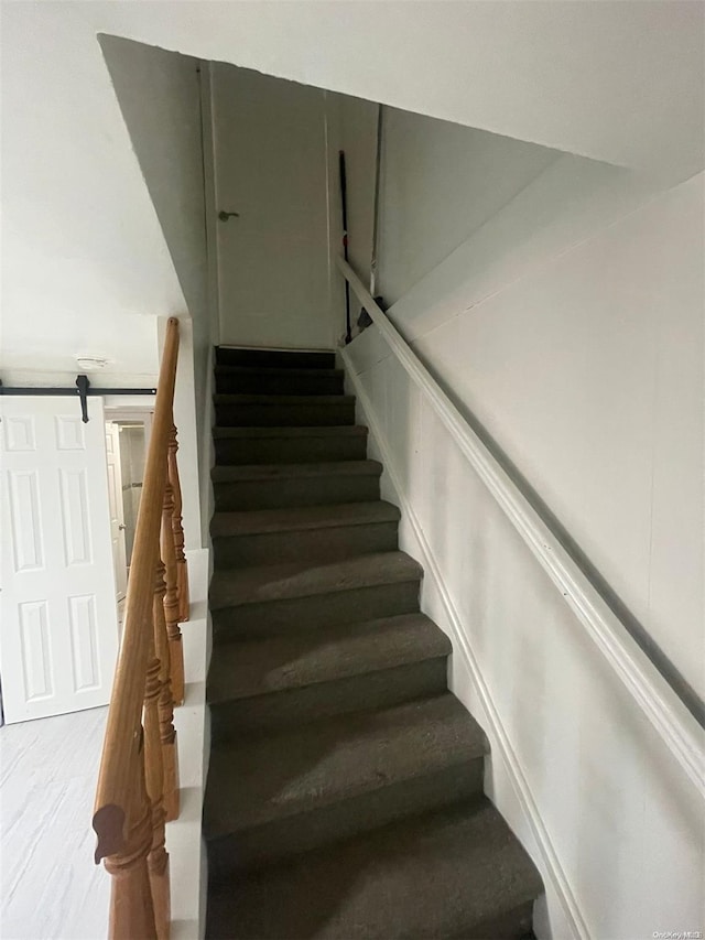 staircase featuring a barn door