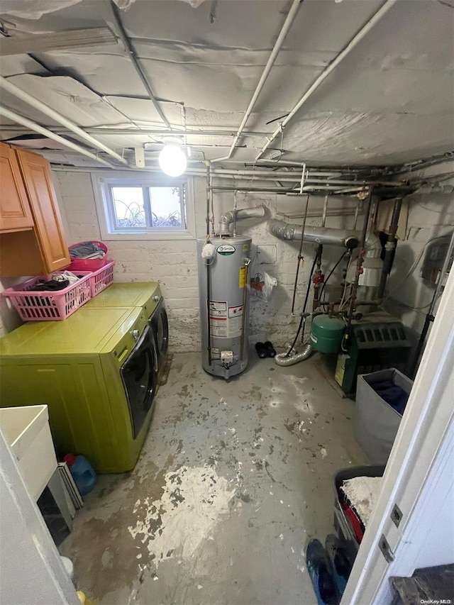 basement featuring washer and clothes dryer and water heater