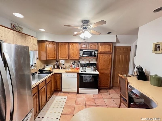 kitchen with ceiling fan, light tile patterned floors, sink, and appliances with stainless steel finishes