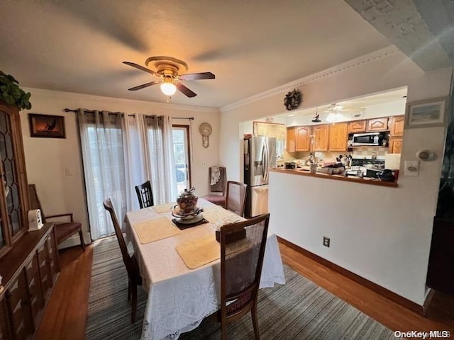 dining area with dark hardwood / wood-style floors, ceiling fan, and ornamental molding