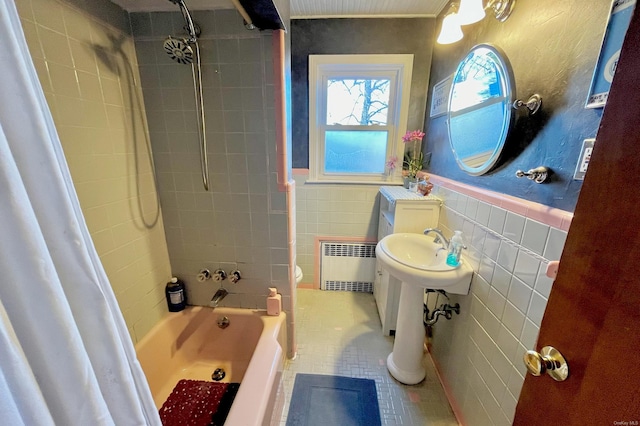 bathroom with radiator, tile walls, toilet, shower / bath combo, and tile patterned floors