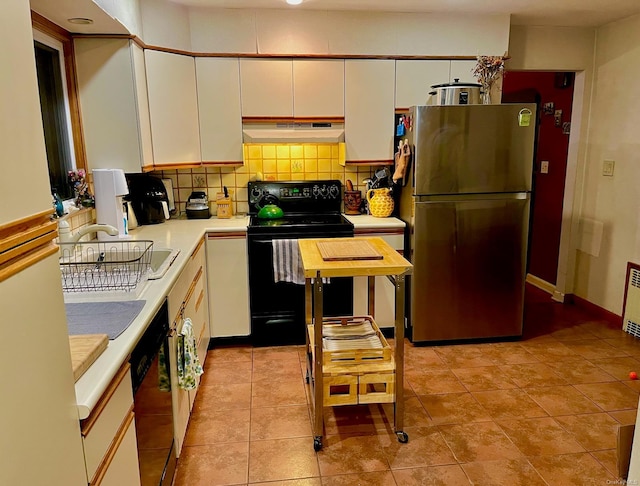 kitchen with tasteful backsplash, light tile patterned floors, white cabinets, and black appliances