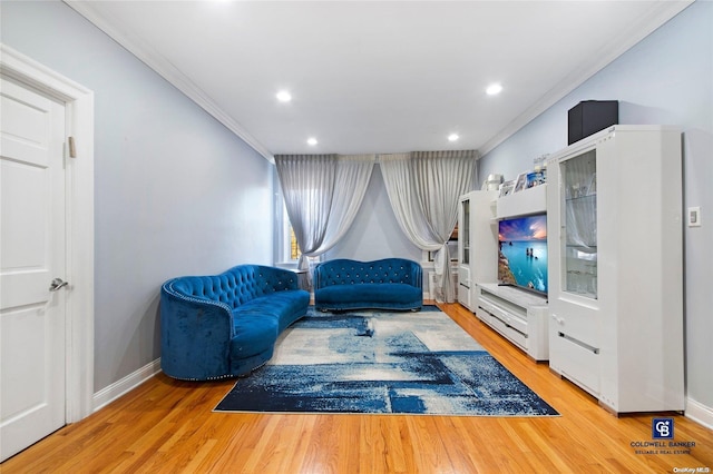 sitting room with light hardwood / wood-style flooring and ornamental molding