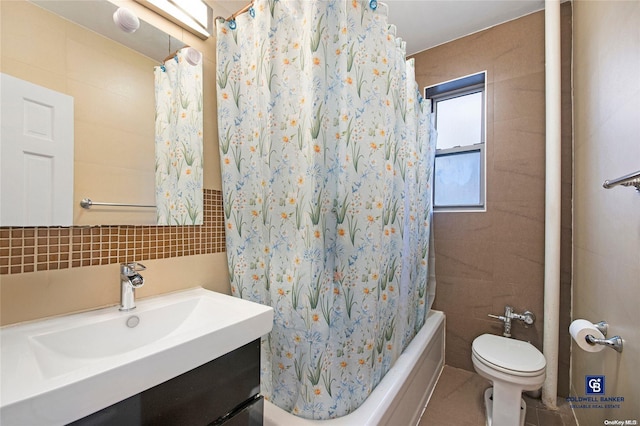 full bathroom with shower / bath combo, toilet, and tile walls