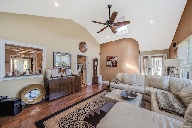 living room with vaulted ceiling, ceiling fan, and dark hardwood / wood-style flooring