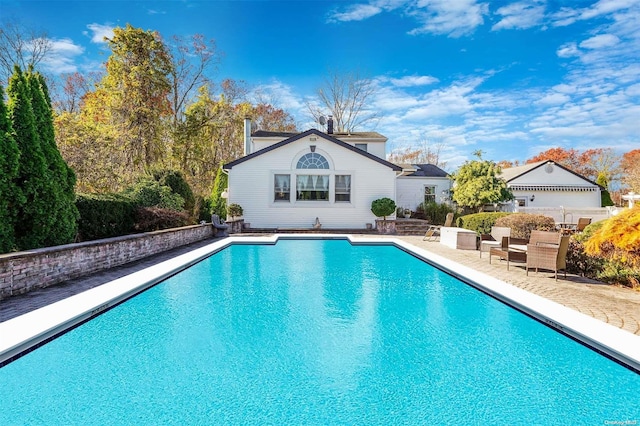 view of pool with a patio area and an outdoor structure