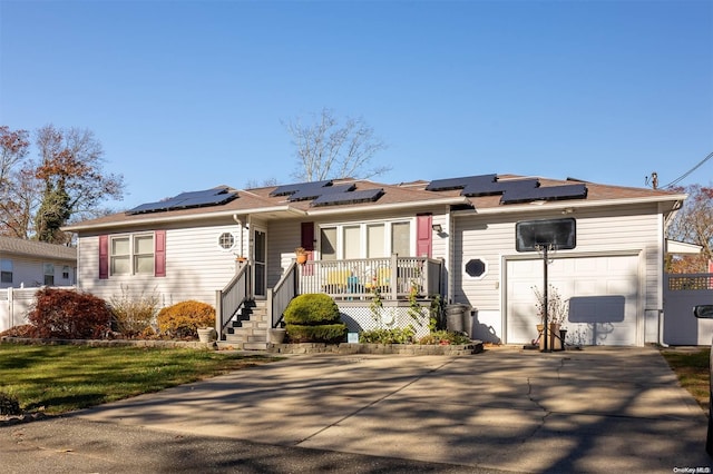 single story home featuring solar panels and a garage