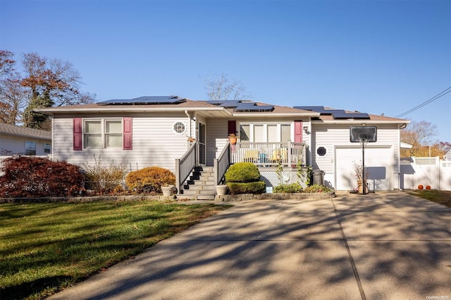 view of front of property with solar panels and a front lawn