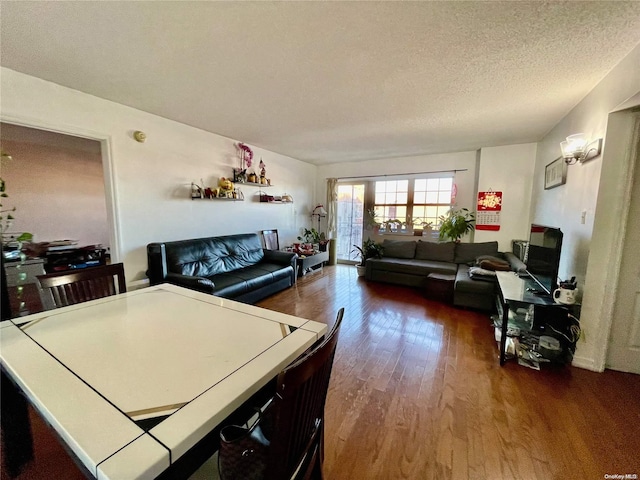 kitchen featuring dark wood-type flooring and a textured ceiling