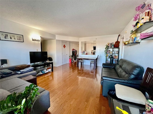 living room with hardwood / wood-style floors and a textured ceiling