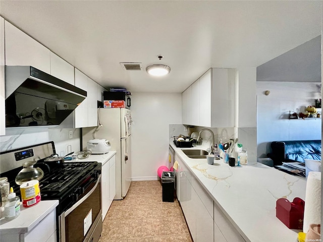 kitchen featuring extractor fan, white cabinets, stainless steel range with gas cooktop, and sink