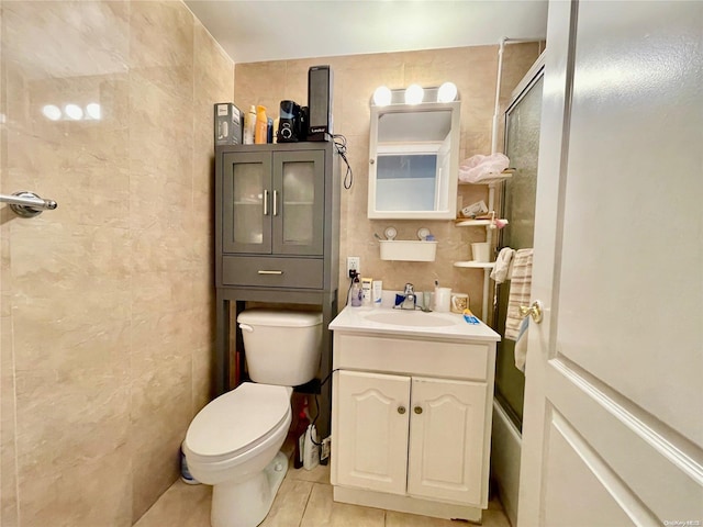 full bathroom with tile patterned floors, tile walls, and toilet