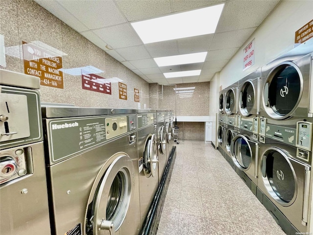 clothes washing area featuring stacked washing maching and dryer and washing machine and clothes dryer